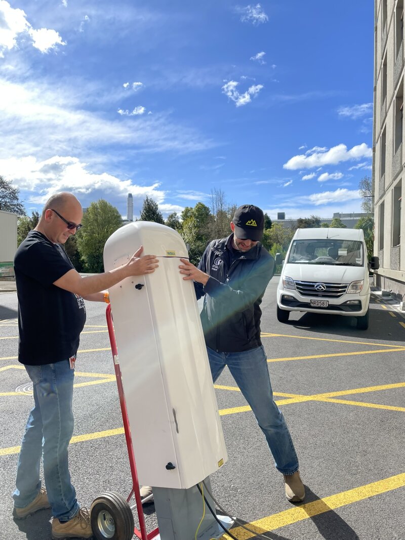 Two people
moving the ceilometer using a hand truck